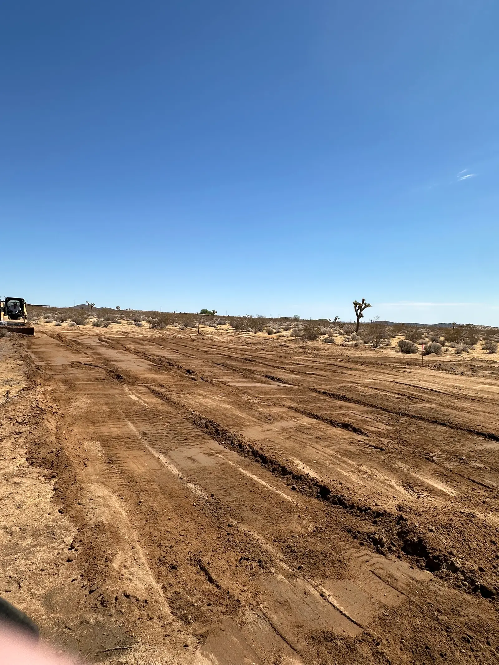 The building pad part-way through backfill, showing a compacted layer of fill.